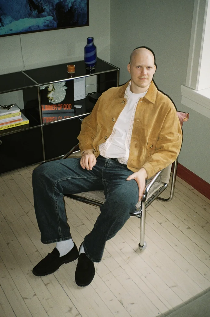 Mustard jacket over a white t-shirt and dark jeans